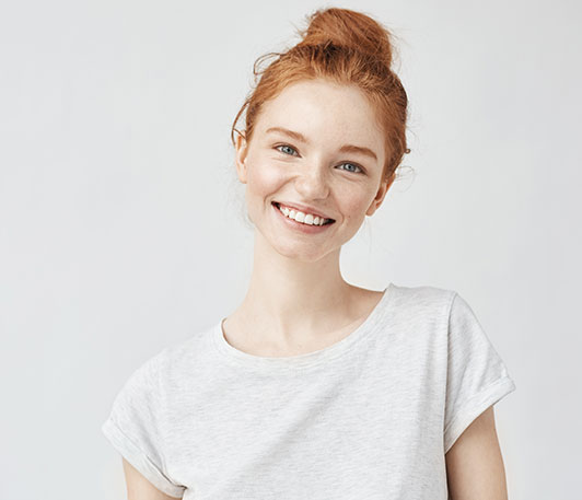 woman smiling with tilted shoulders